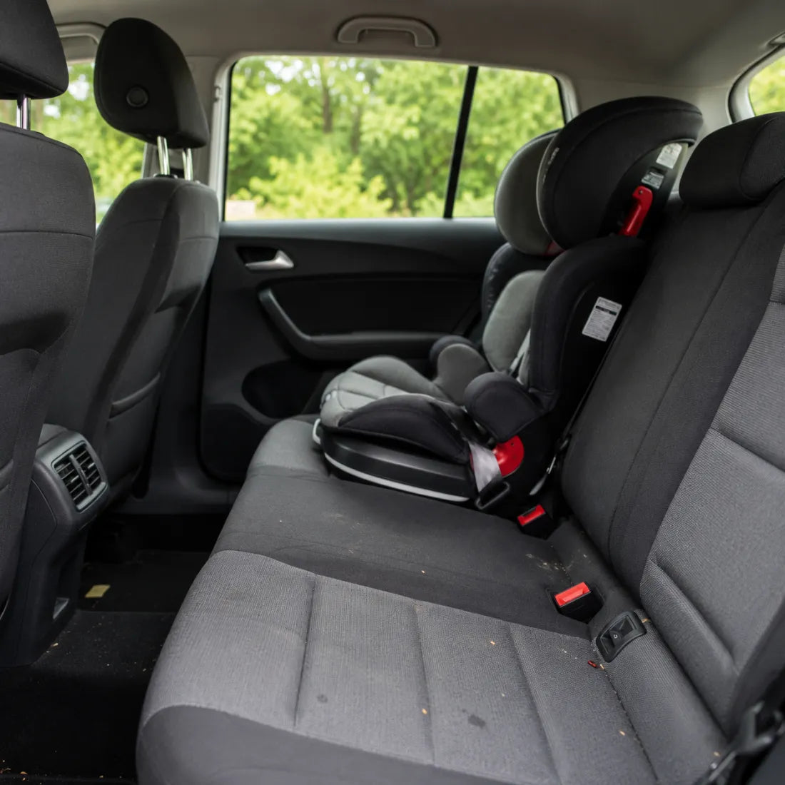 Stoff-Autositz mit Kindersitz und leichten Alltagsspuren